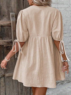 Beige tie front puff sleeve mini dress with adjustable tie cuffs