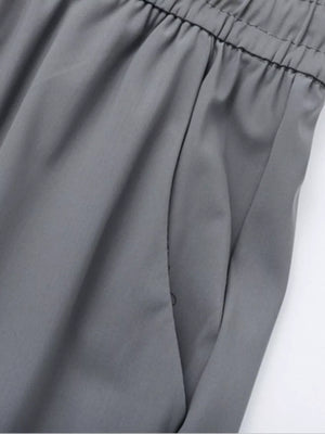 Grey sweatpants with elastic waistband and side pocket detail