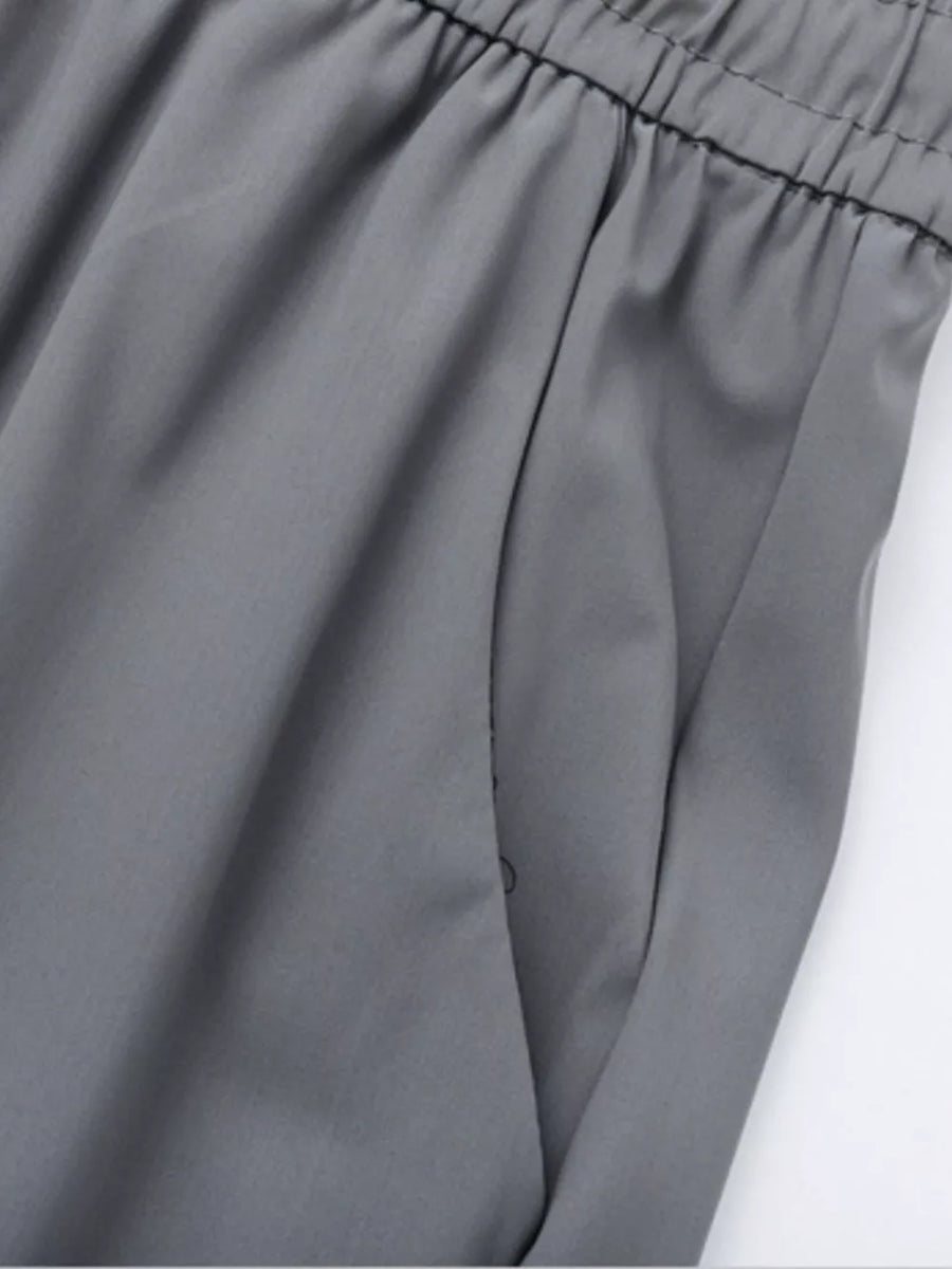 Grey sweatpants with elastic waistband and side pocket detail
