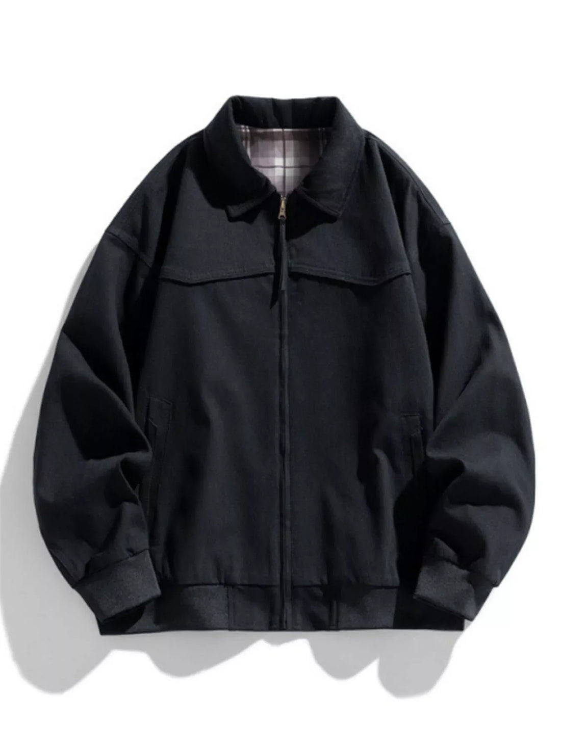 Black oversized zip-up jacket with plaid lining and elastic cuffs.