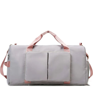 Light Gray duffel bag with pink trim and straps, featuring a front pocket with two vertical zip compartments.
