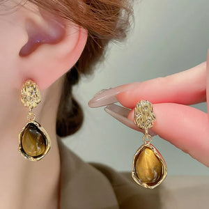 earrings in golden yellow with geometric and geometric beads