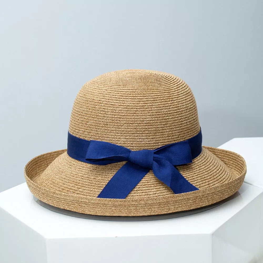 Elegant straw sun hat with blue ribbon bow detail