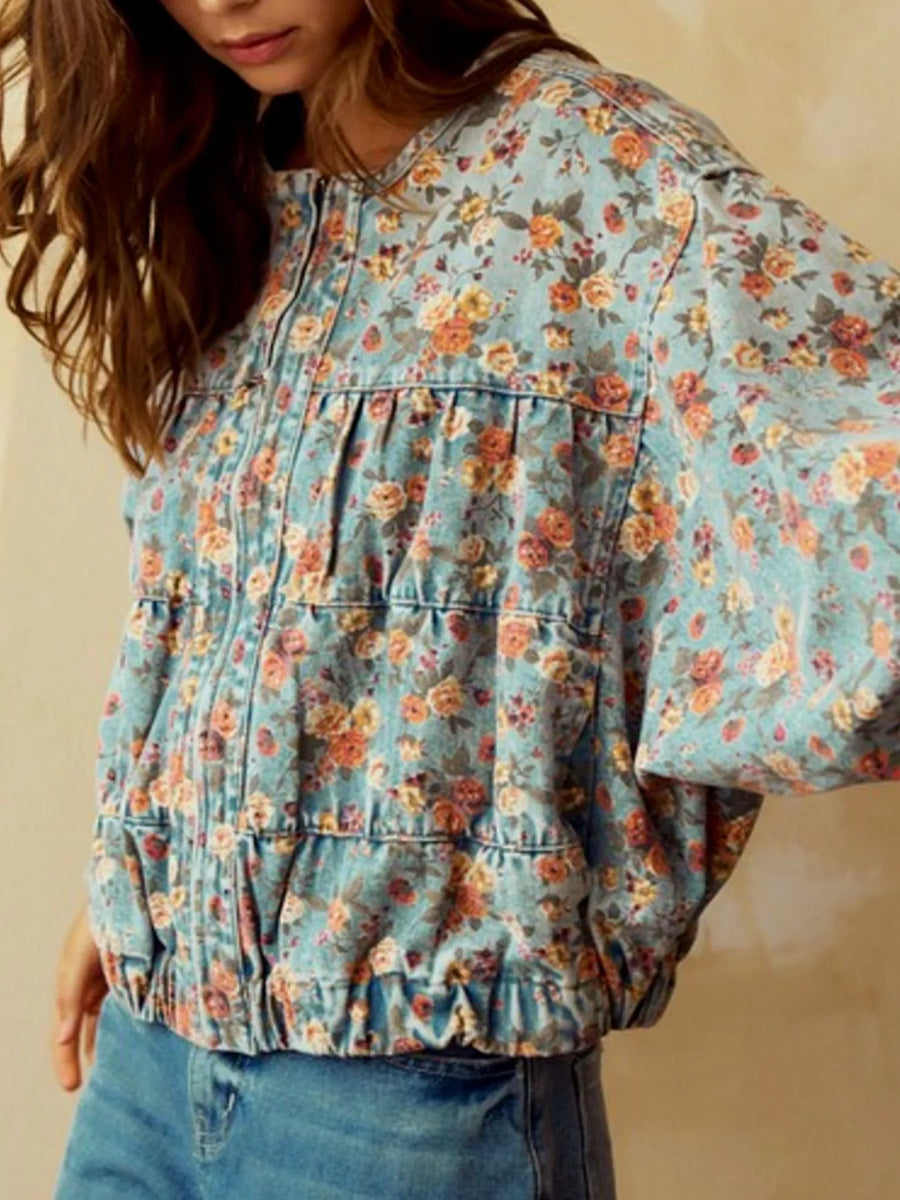 Cropped denim trucker jacket with allover floral print and elasticized hem.