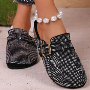 Black rhinestone buckle slip-on mules with a casual chic style.