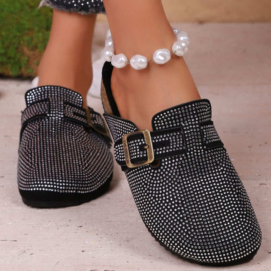 Black rhinestone buckle slip-on mules with a casual chic style.