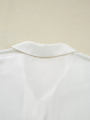 White linen blend shirt with a classic collar and subtle texture.