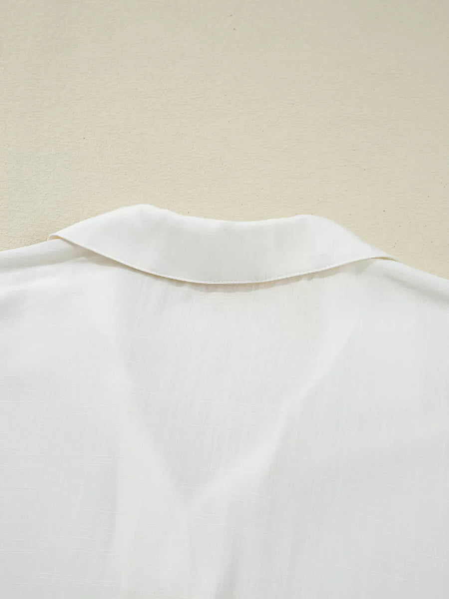 White linen blend shirt with a classic collar and subtle texture.