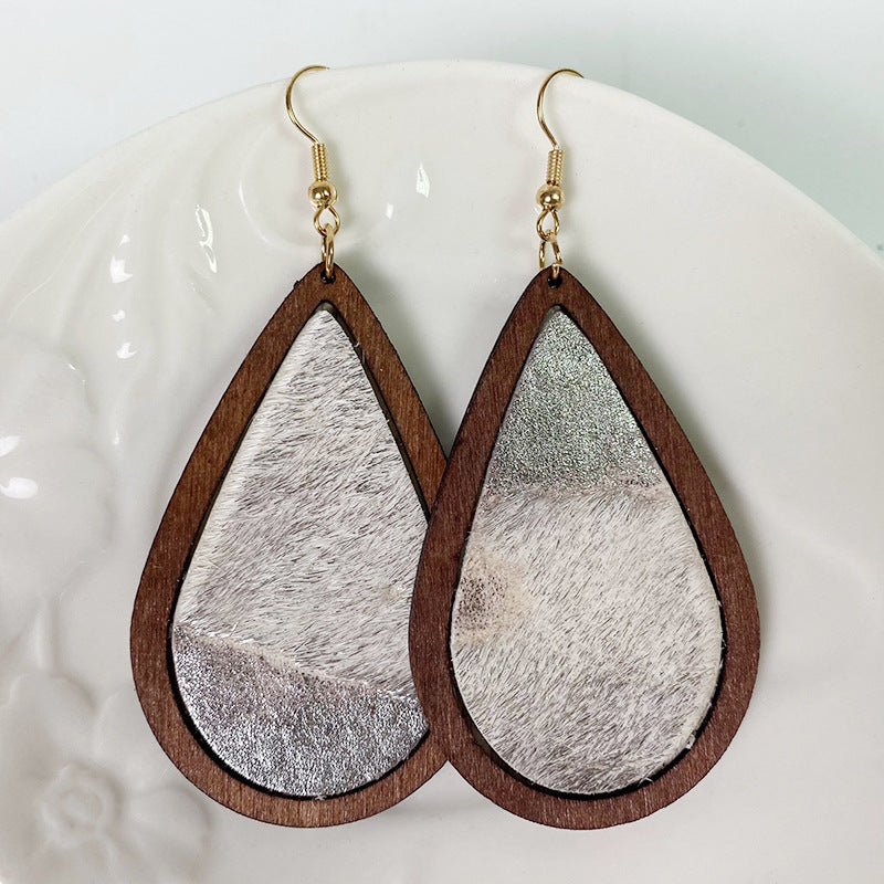 Teardrop wood earrings with cowhide and silver accents.