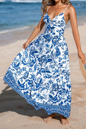 Maxi dress with blue Chinoiserie floral print, cutout detail, and tiered skirt.