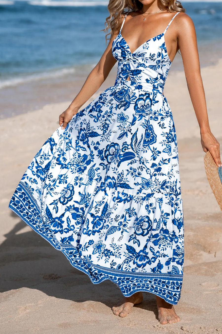 Maxi dress with blue Chinoiserie floral print, cutout detail, and tiered skirt.