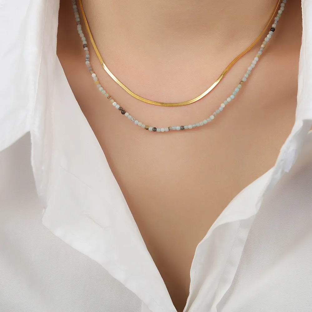 Gold serpentine and beaded layered necklace set with crystal accents