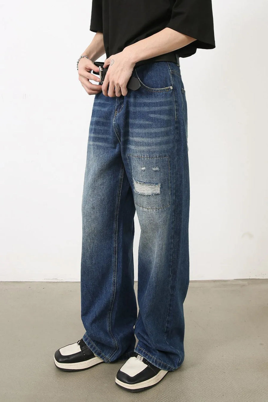 Baggy patchwork denim jeans in medium vintage wash with distressed details.