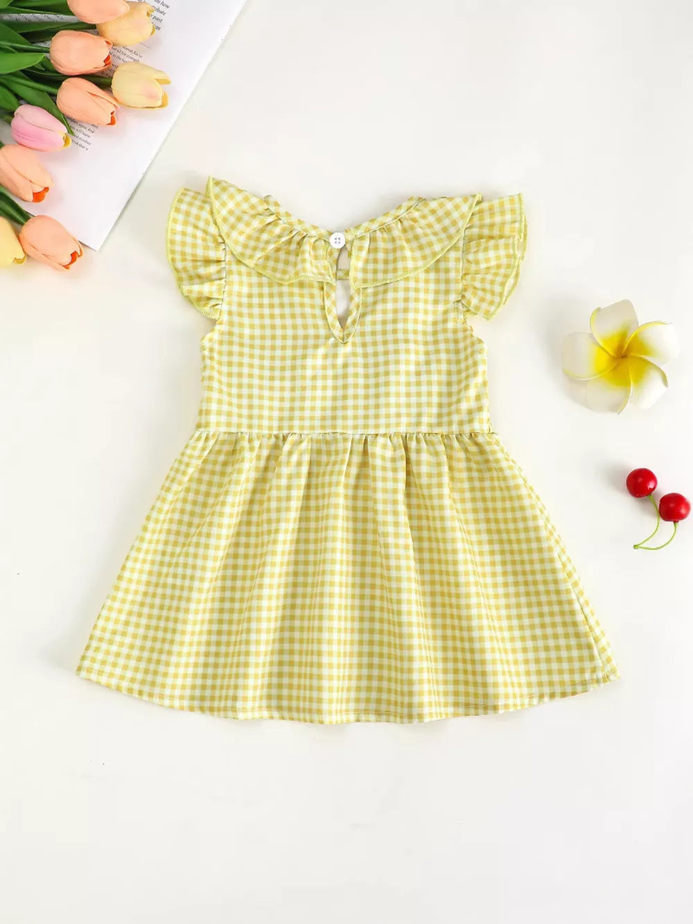 Yellow gingham baby dress with ruffle collar and sleeves.