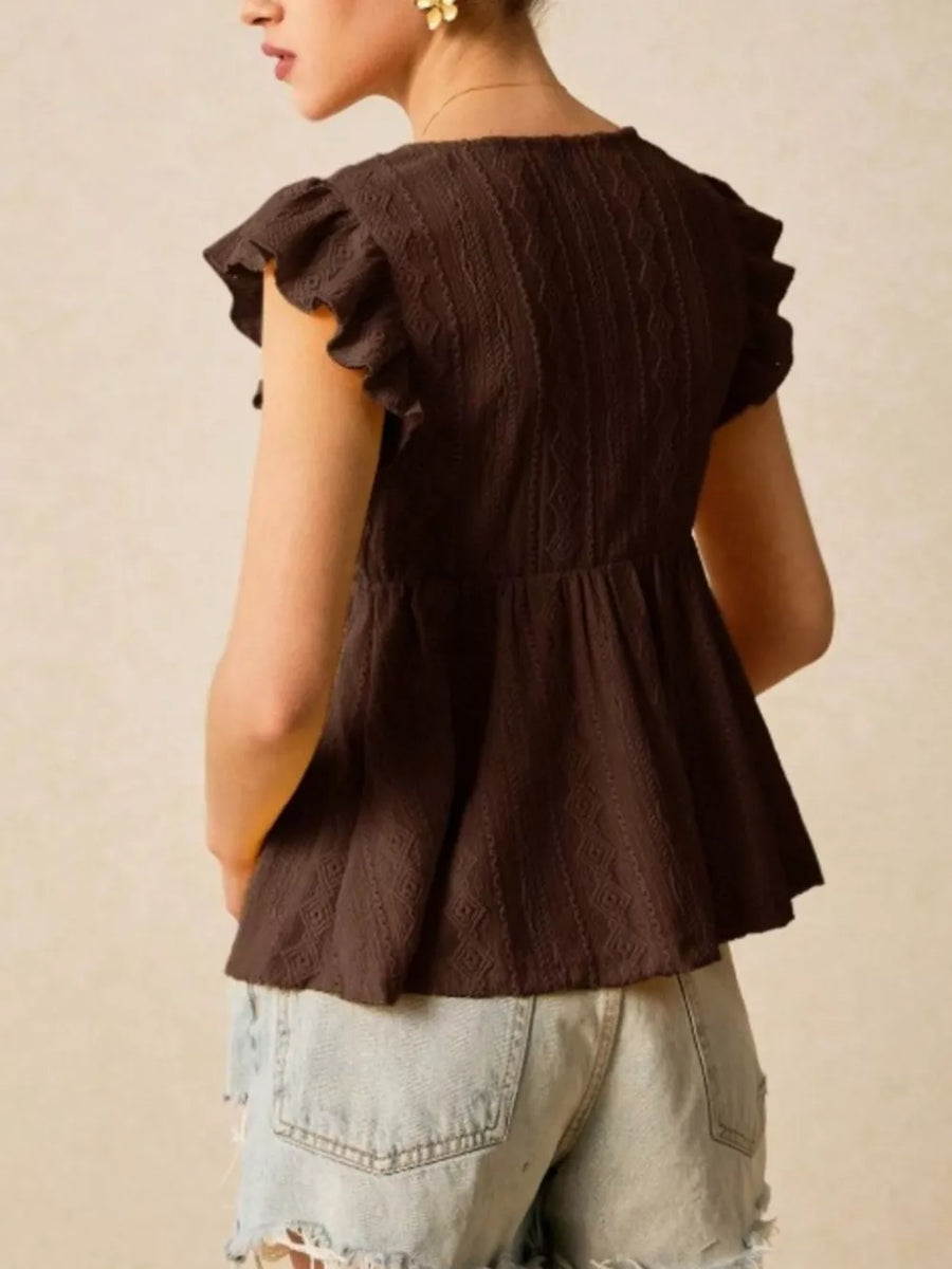 Brown eyelet peplum blouse with ruffle sleeves and textured fabric.