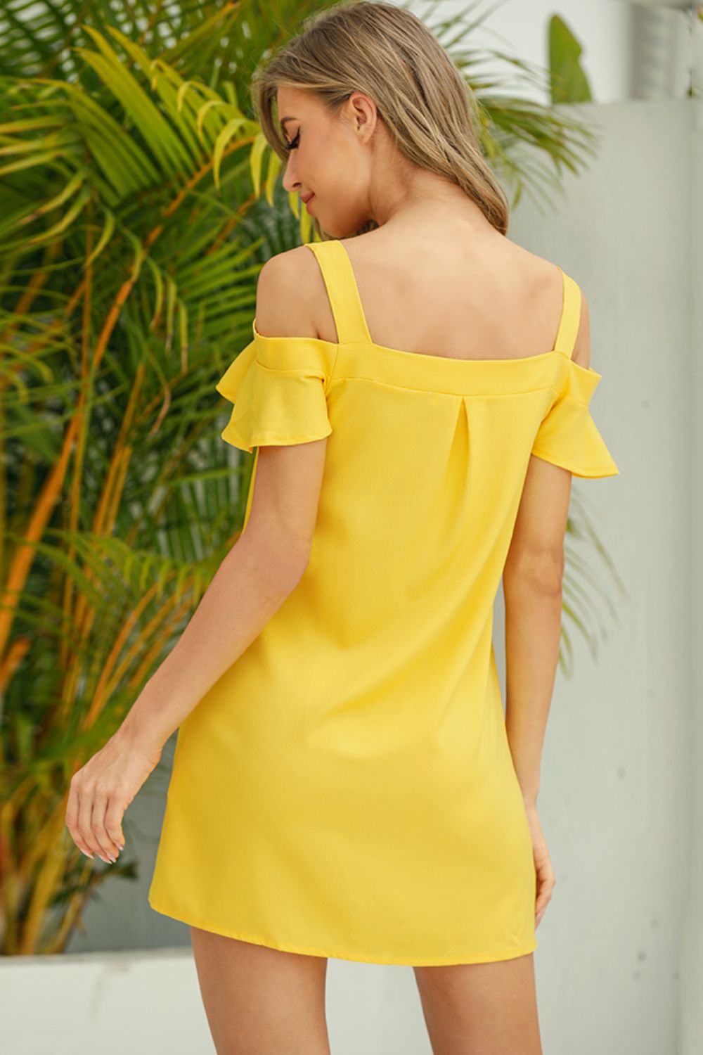 Yellow mini dress with ruffled cold shoulder straps and square neckline.