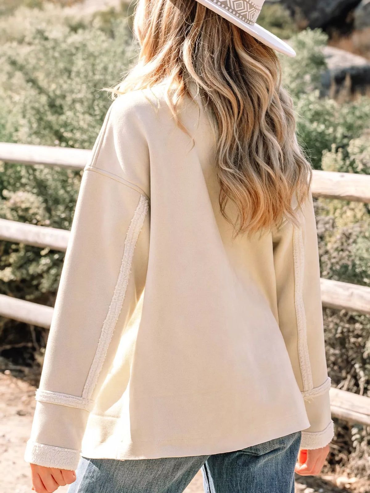 Lined western jacket in eggshell with sherpa trim details on sleeves and sides.