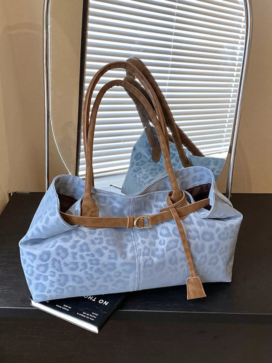 Blue leopard print PU leather shoulder bag with brown straps and buckle detail.