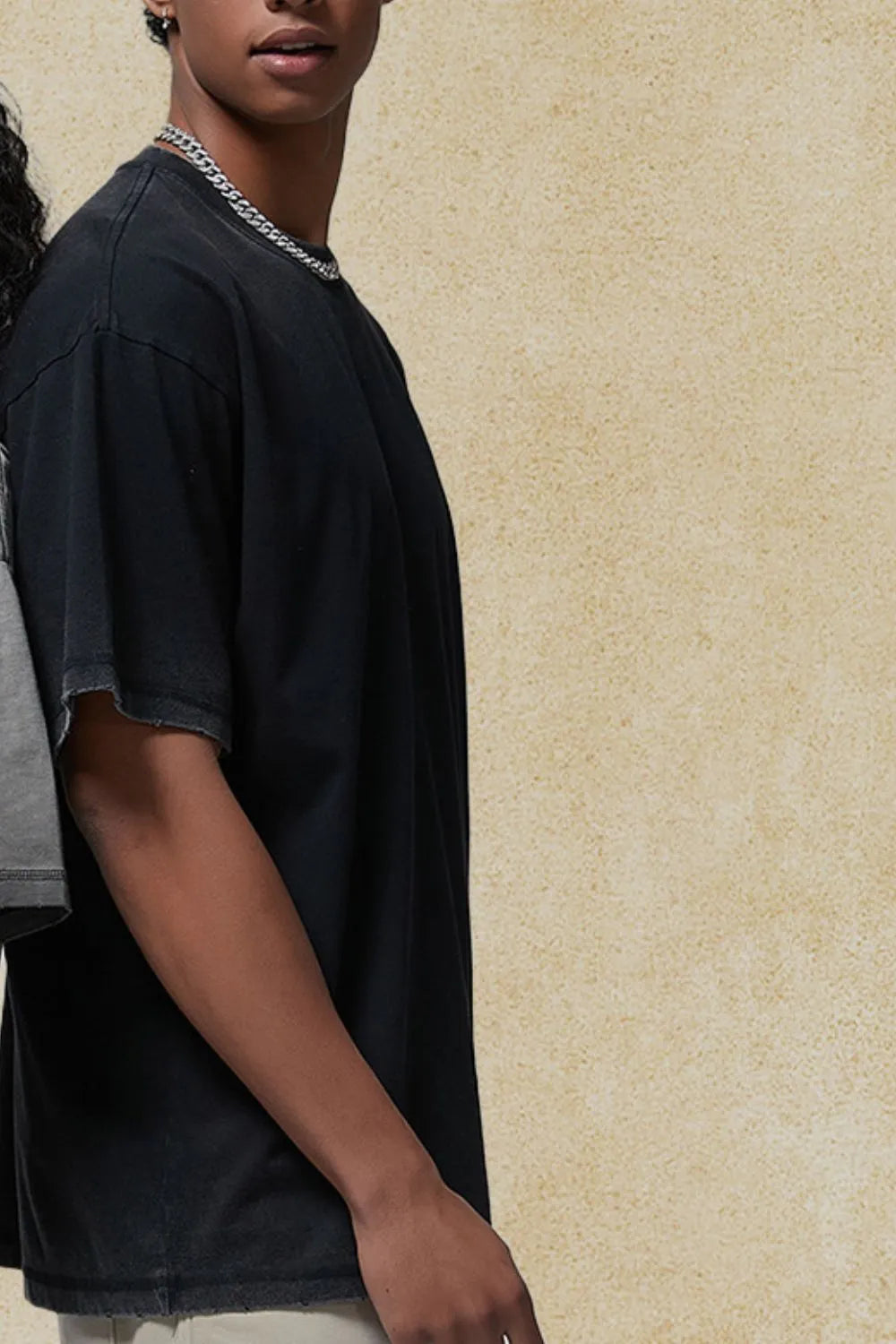 Washed black oversized t-shirt with distressed hem and neckline, short sleeves.