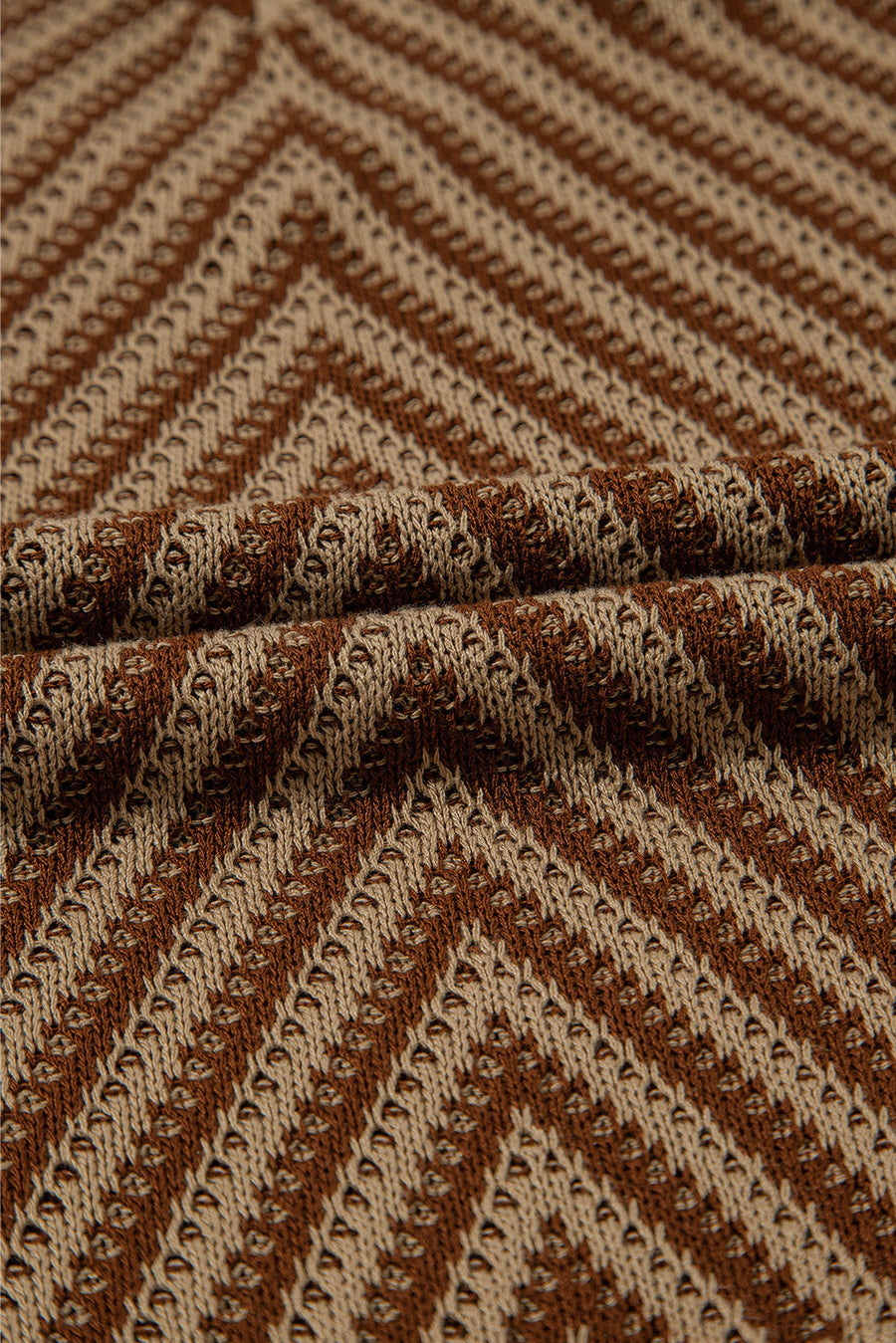 Chevron knit vest in brown and tan with open-knit texture and diagonal stripes.