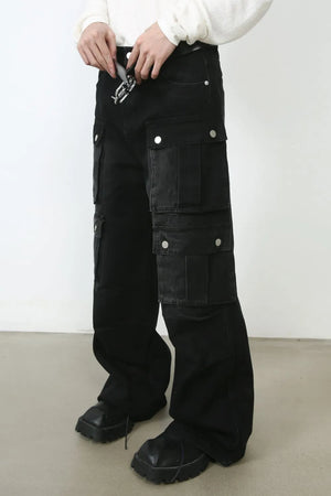 Oversized dark denim cargo pants with multiple pockets and a silver buckle belt detail.