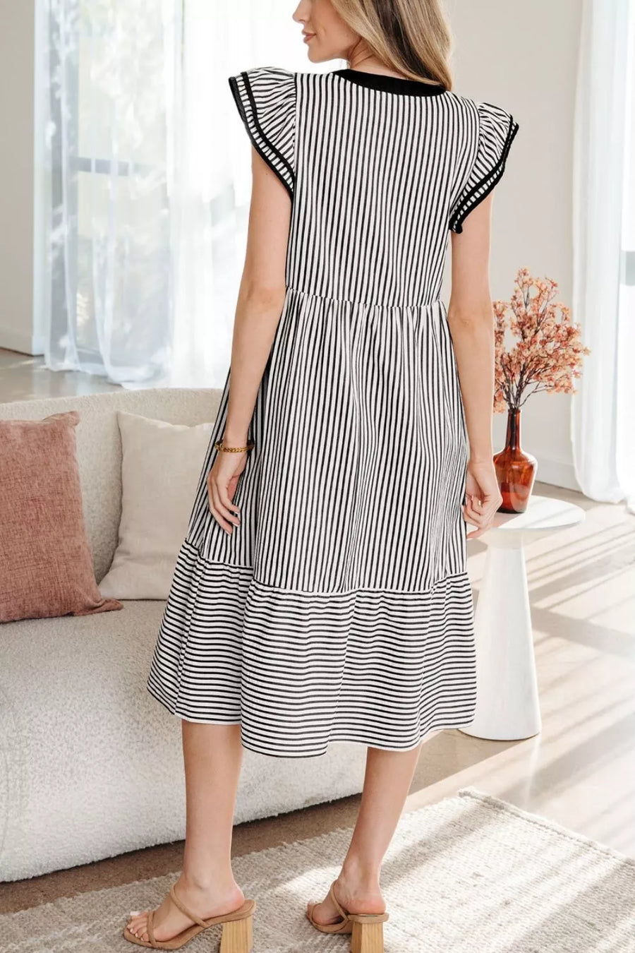 Black and white striped cotton midi dress with tiered skirt and flutter sleeves.