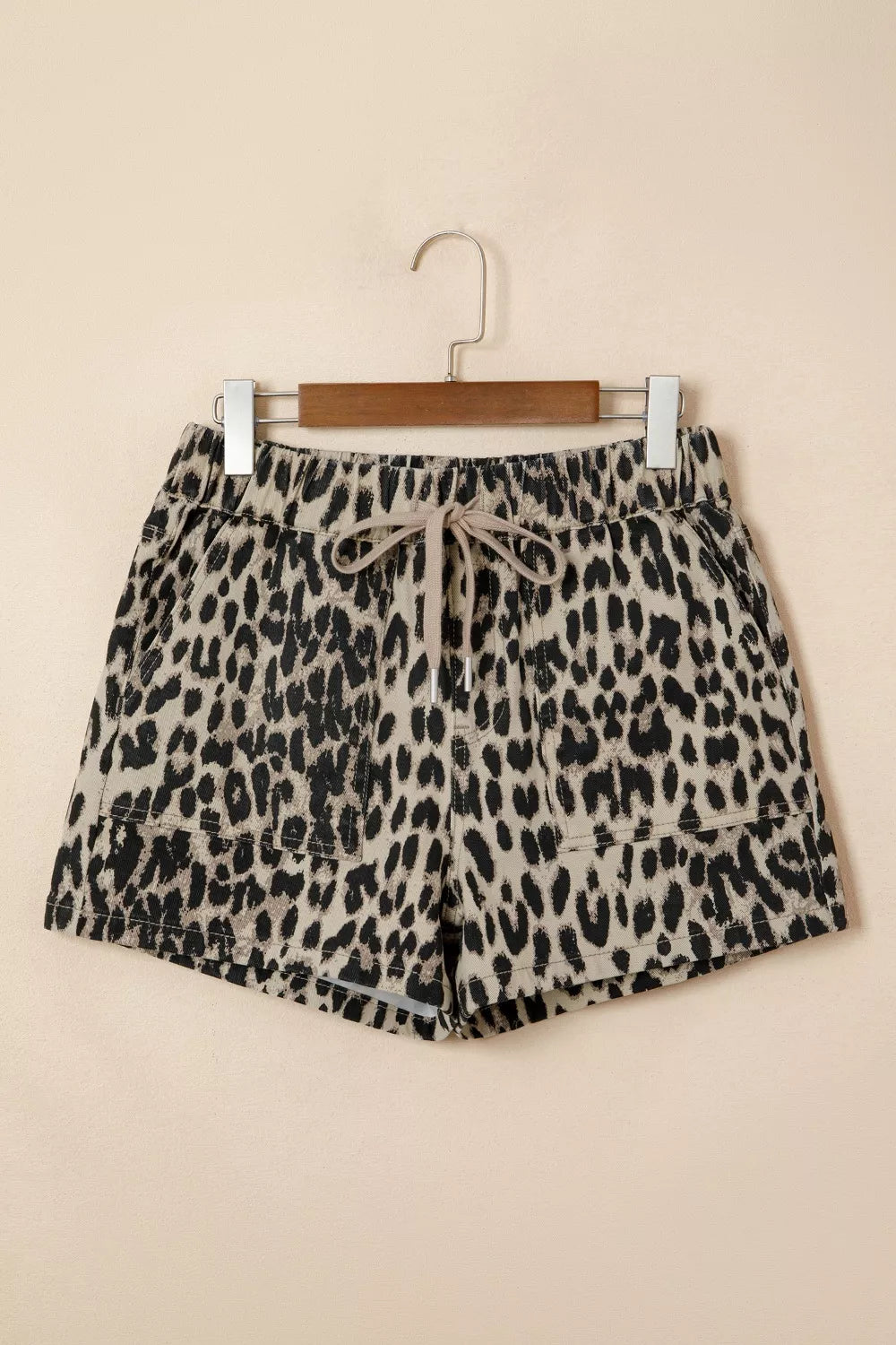 Denim shorts with leopard print, drawstring waist, and pockets.