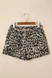 Denim shorts with leopard print, drawstring waist, and pockets.