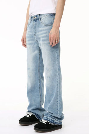 Baggy light wash denim jeans with distressed details and raw hem