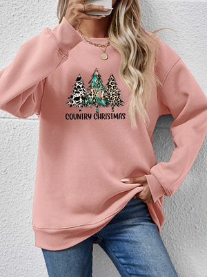 Blush pink sweatshirt with country Christmas trees graphic and text.