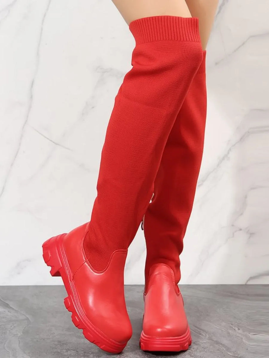 Red knit-top platform over-the-knee boots with a chunky sole.