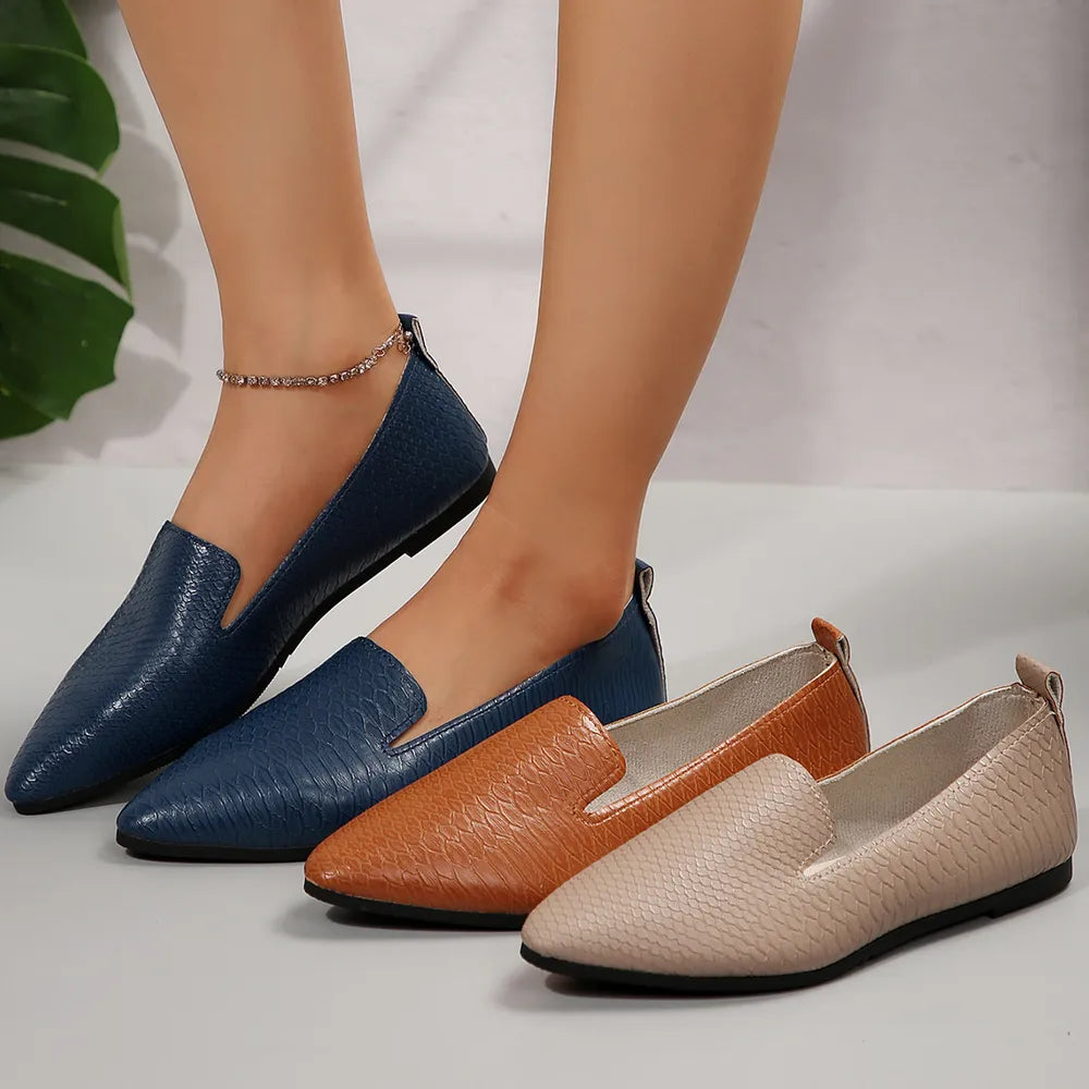 Textured pointed-toe slip-on loafers in navy, ochre, and dust storm with a subtle embossed pattern.