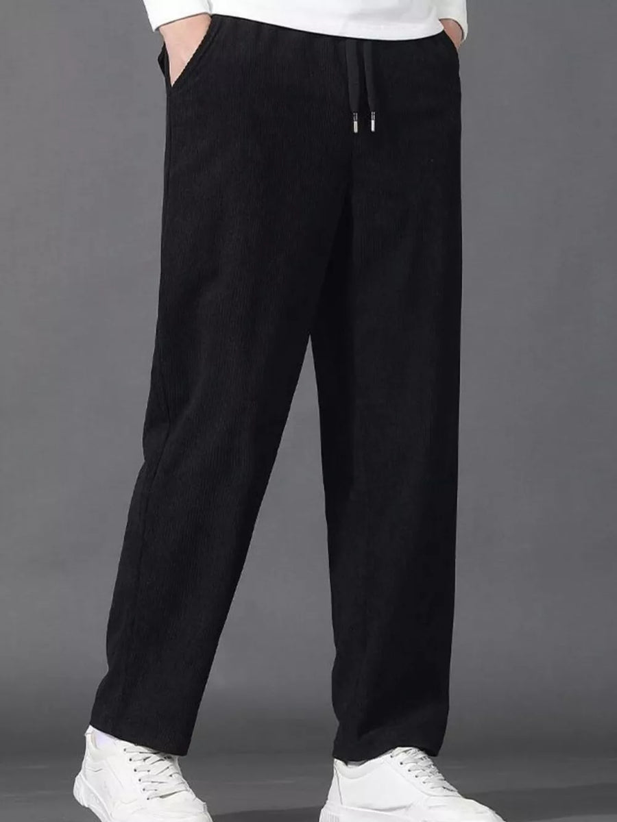Black corduroy joggers with drawstring waist and pockets.