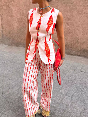 Red fish print two-piece set with button detail on sleeveless top and wide-leg pants.
