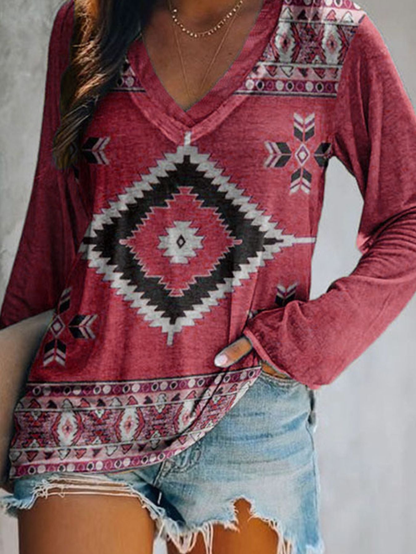Red geometric print V-neck long sleeve t-shirt with bohemian pattern detail.