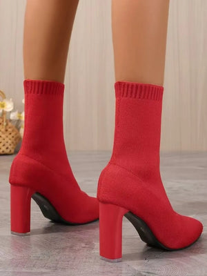 Red knit sock booties with a sculpted block heel and ribbed cuff.