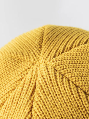 Yellow ribbed knit beanie with distressed detail