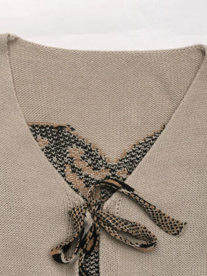 Gray apricot knit cardigan with patterned V-neck and tie front detail.