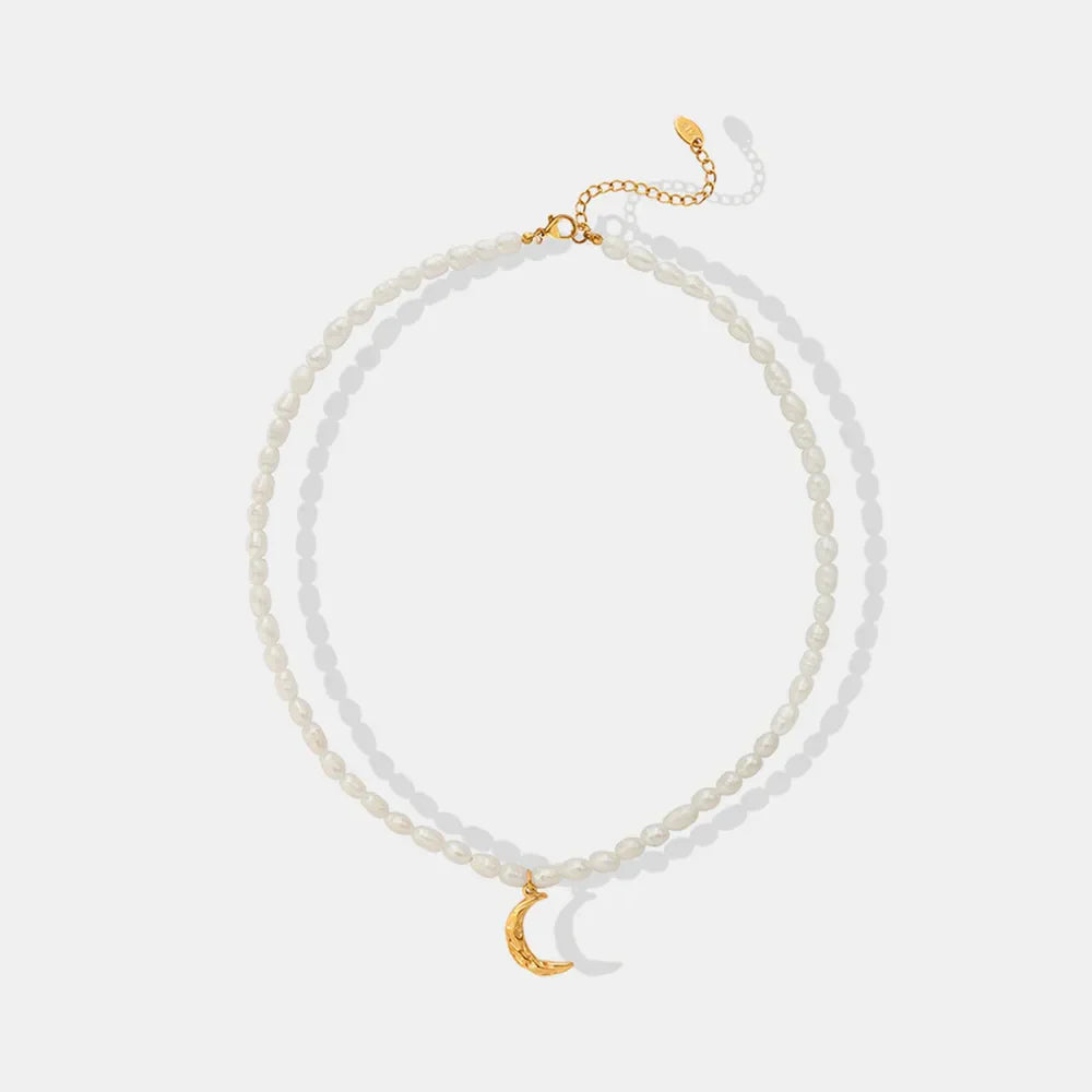 Gold pearl choker necklace with a textured crescent moon pendant