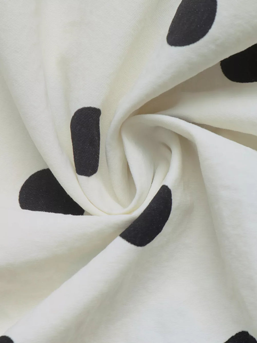 black windbreaker with button-front and polka-dot
