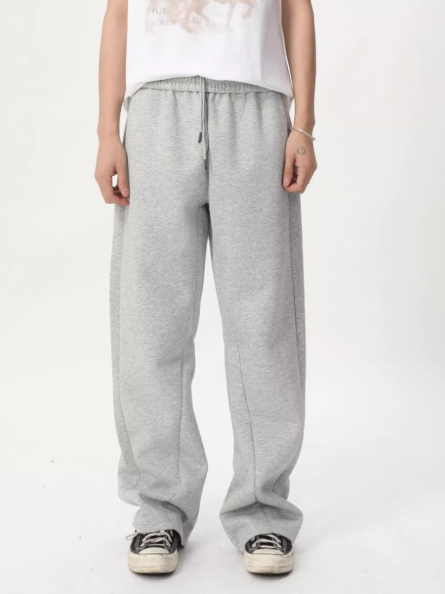 Relaxed fit grey sweatpants with adjustable drawstring waist and wide legs.