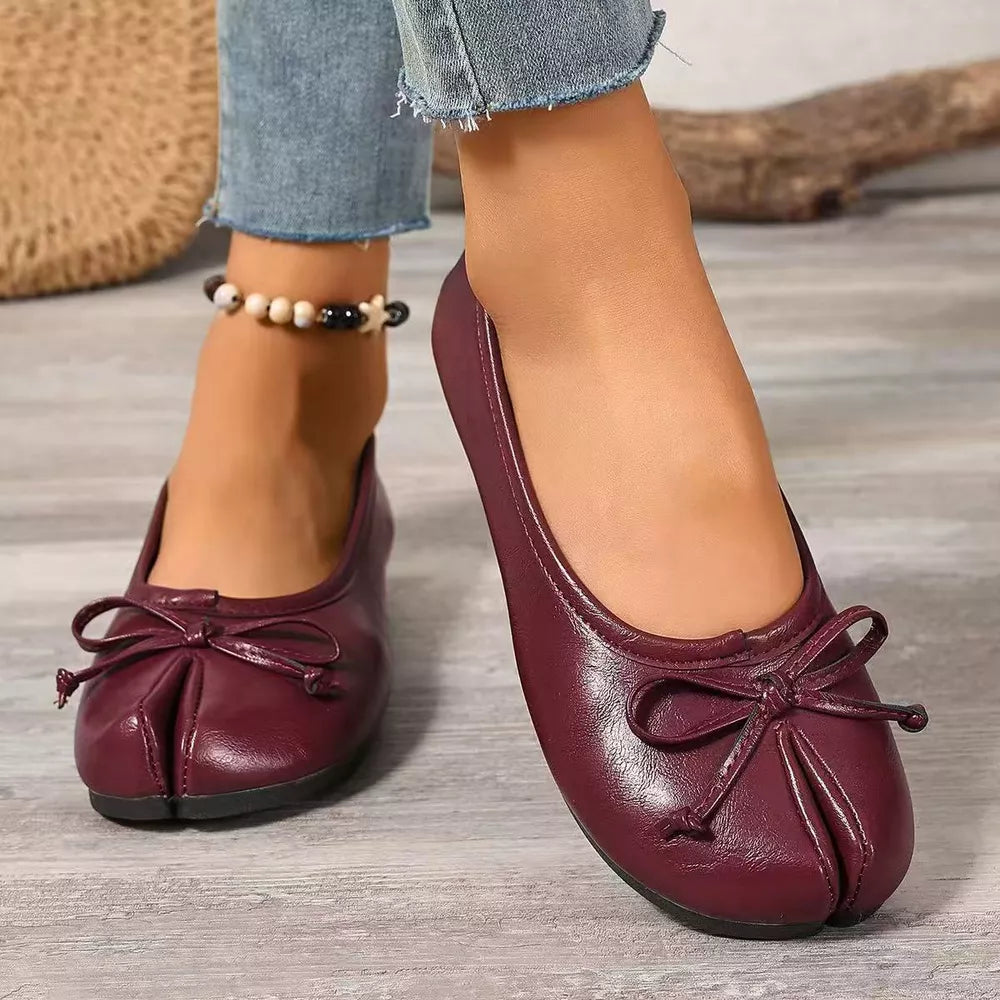 Burgundy tabi slip-on flats with a bow detail and split toe.