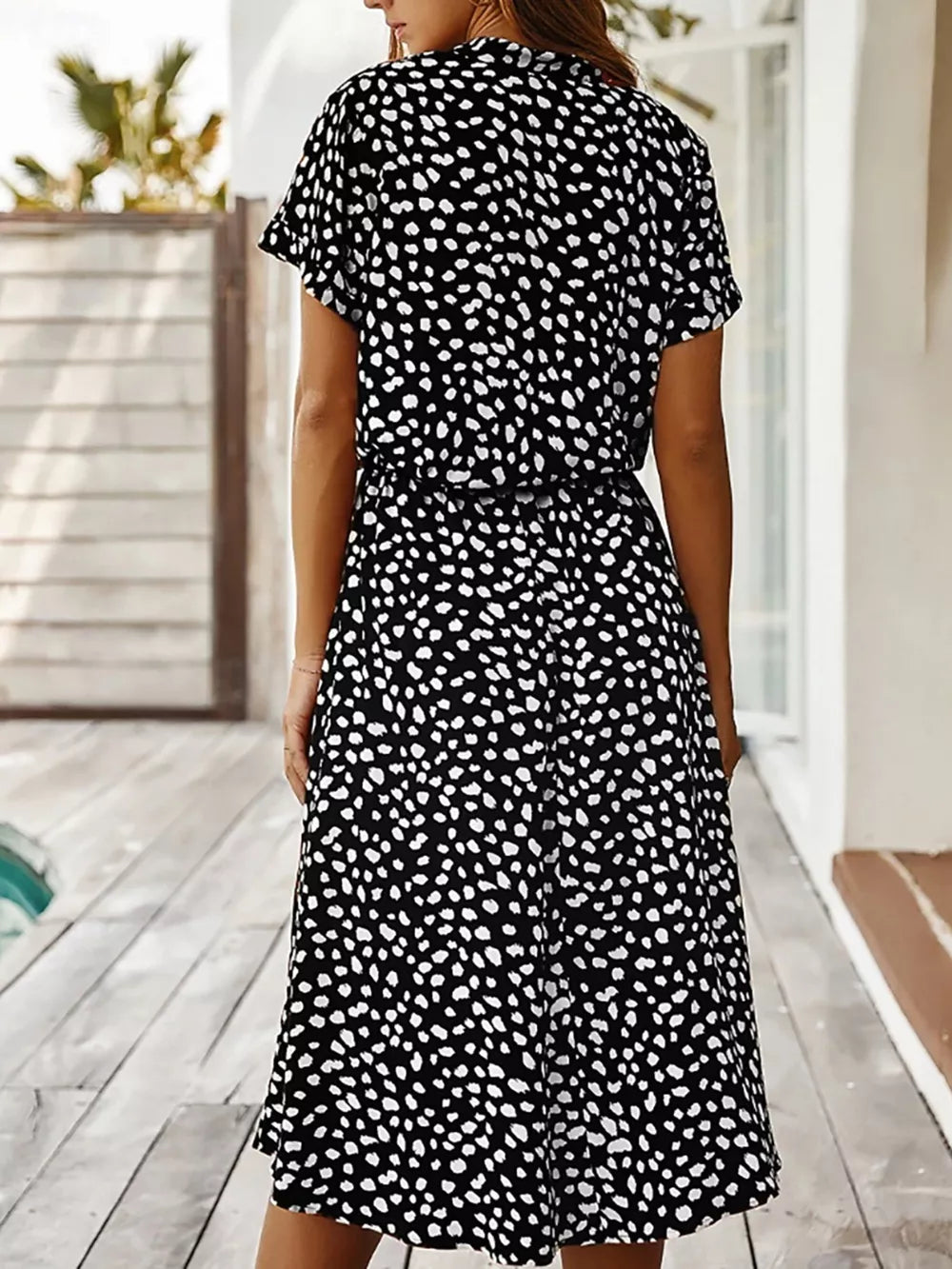 Black polka dot midi dress with short sleeves and pockets