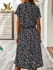 Black polka dot midi dress with short sleeves and pockets