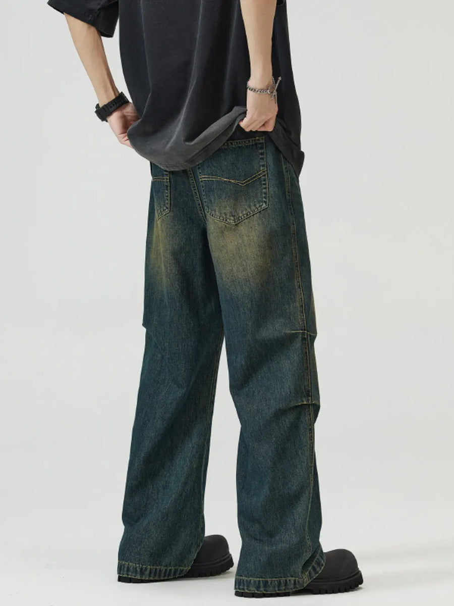 Vintage wash wide-leg men's jeans in dark blue-green denim with a relaxed fit.