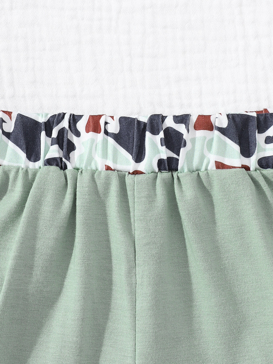 Sage green baby shorts with elastic waistband and camouflage print trim