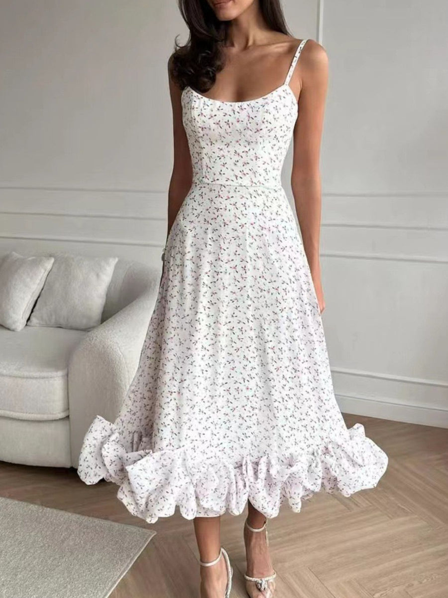 White floral midi dress with spaghetti straps and a ruffled hem