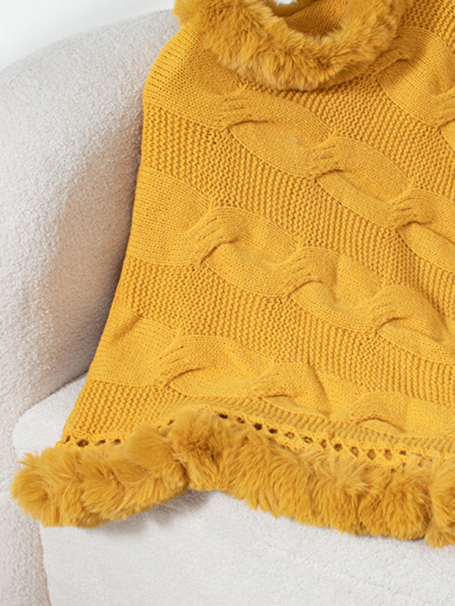 Gold cable knit poncho with faux fur trim and open knit detail