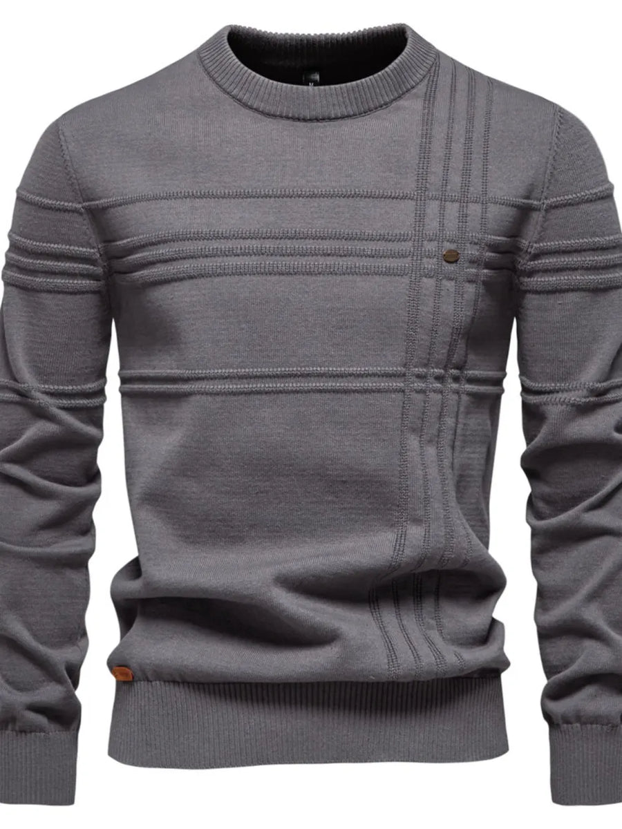 Gray crewneck sweater with textured horizontal and vertical panel details and a button accent.