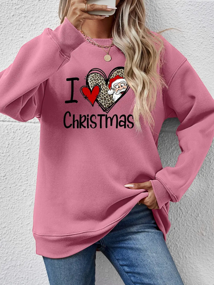 Pink sweatshirt with festive heart graphic and Santa Claus detail.